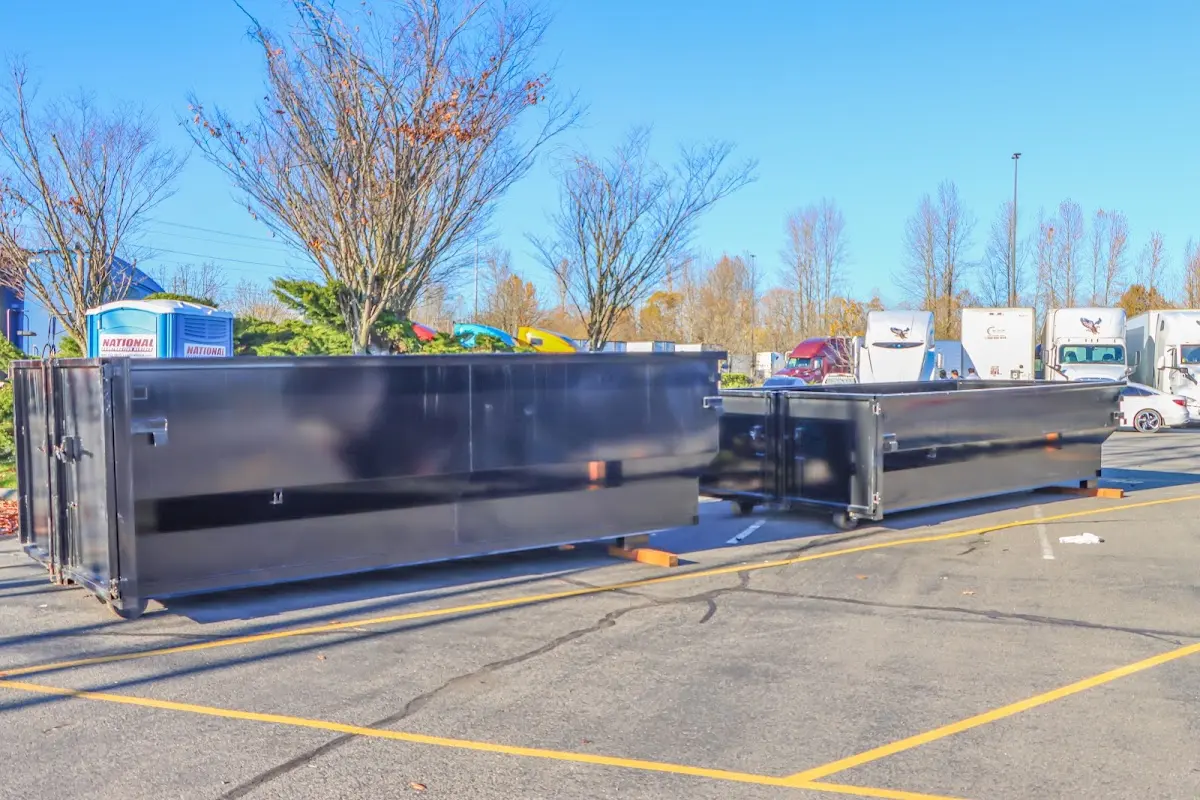 Professional dumpster rental service with roll-off container on residential driveway in Oneida